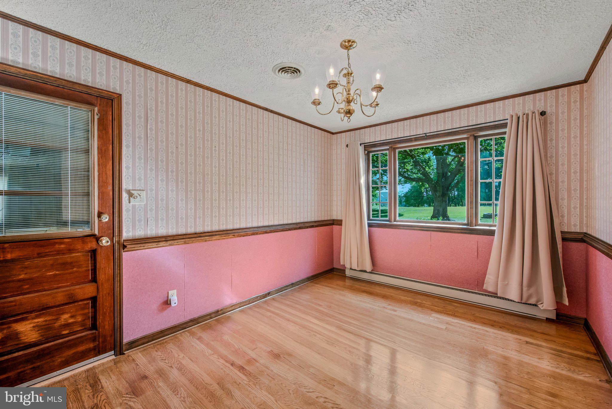 3203 Charles Town Road Kearneysville, WV 25430 - Photo 15 of 45 hardwood floors, chair rail molding and chandelier