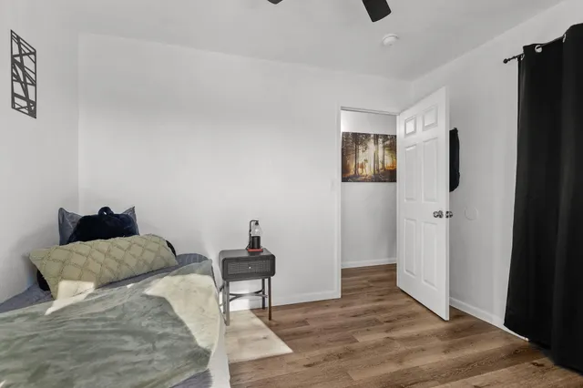 a bedroom with a bed and wooden floor