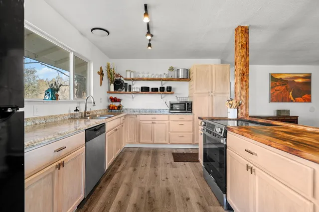 a kitchen with granite countertop white cabinets and white appliances