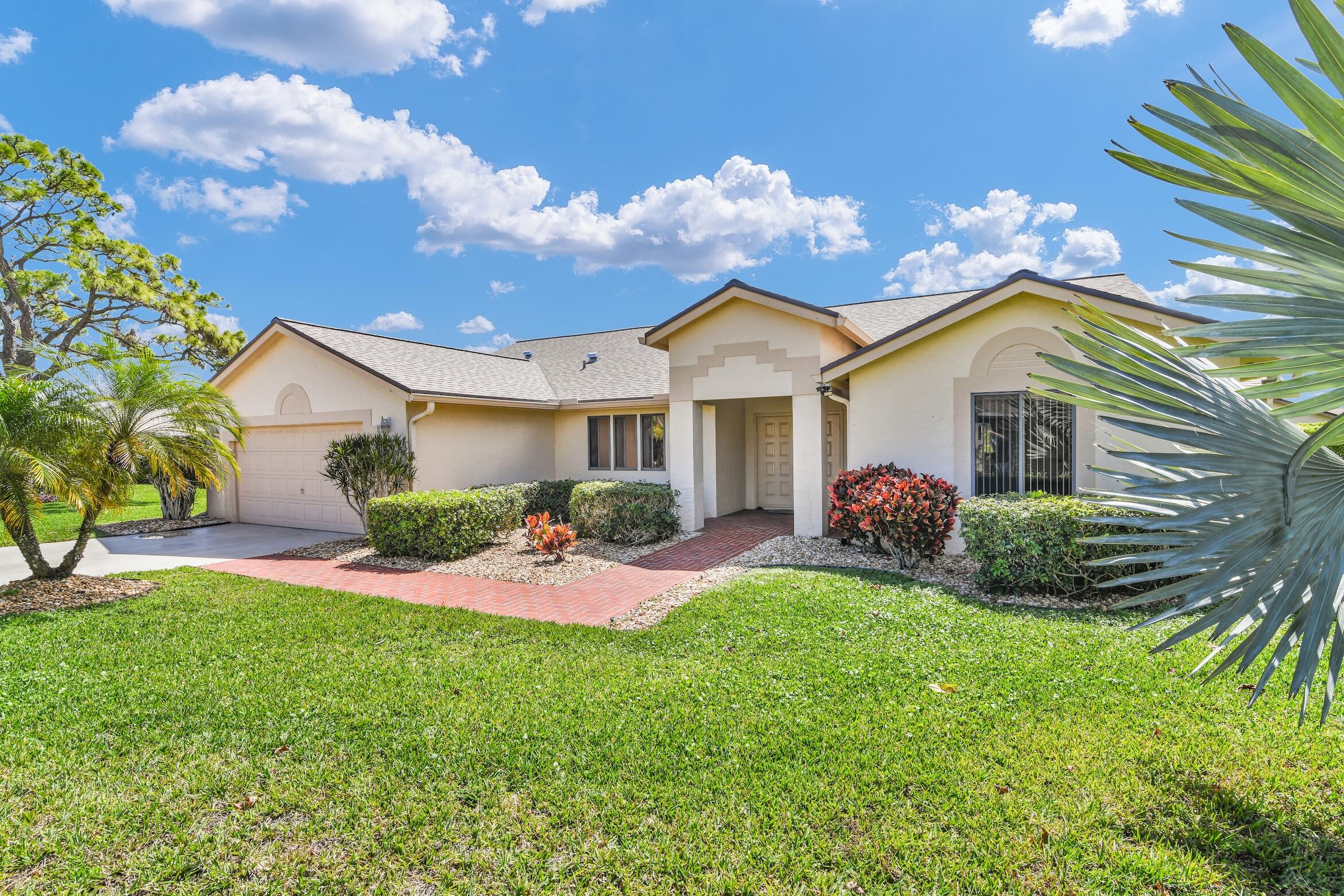 2660 Riviera Drive Delray Beach, FL 33445 - Photo 1 of 40 a front view of a house with garden and porch