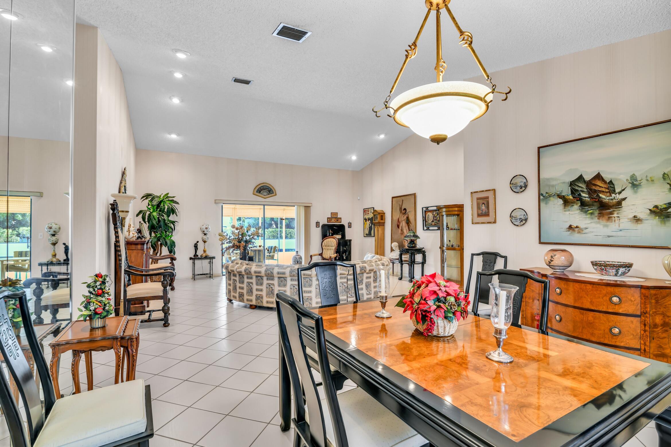 2660 Riviera Drive Delray Beach, FL 33445 - Photo 11 of 40 an open kitchen with dining table and chairs