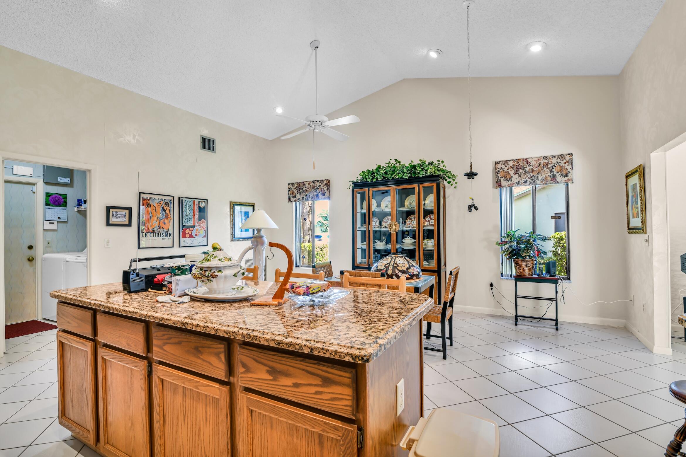 2660 Riviera Drive Delray Beach, FL 33445 - Photo 16 of 40 a kitchen with stainless steel appliances granite countertop a sink and a refrigerator