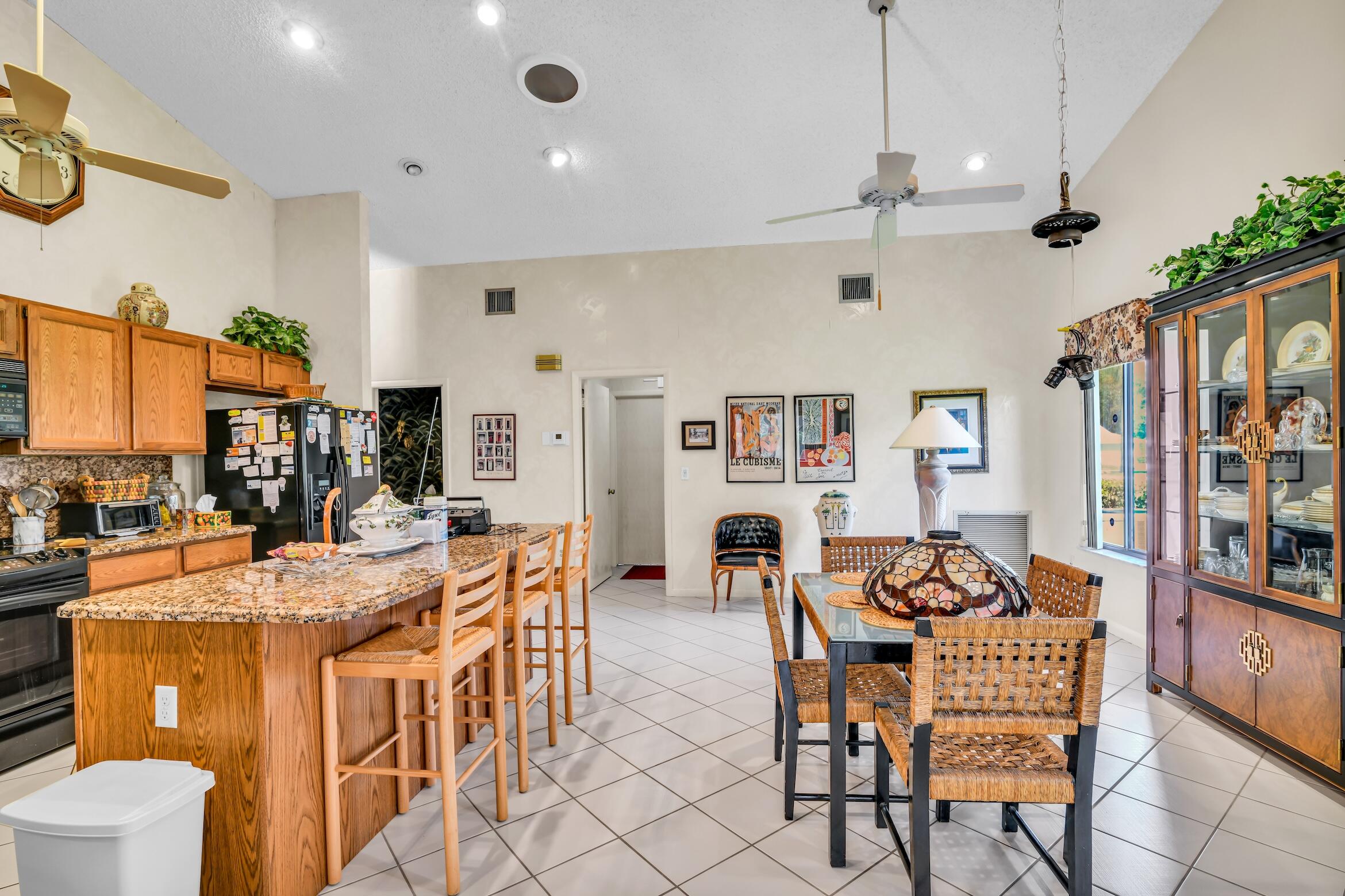 2660 Riviera Drive Delray Beach, FL 33445 - Photo 18 of 40 a view of a dining room with furniture window and wooden floor