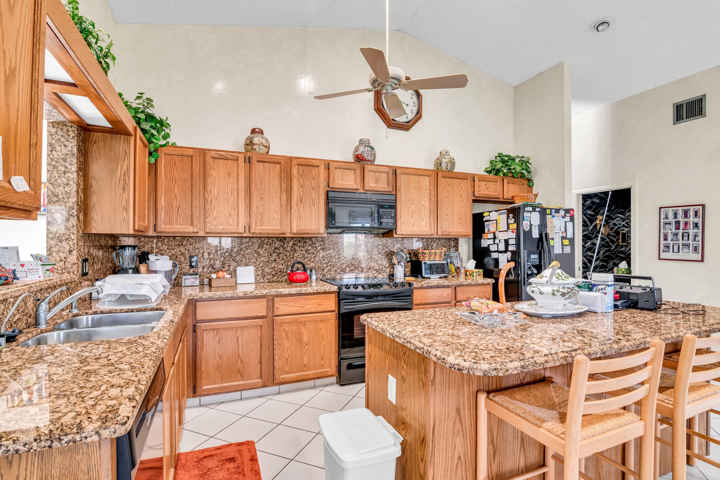 2660 Riviera Drive Delray Beach, FL 33445 - Photo 19 of 40 a kitchen with granite countertop lots of counter top space
