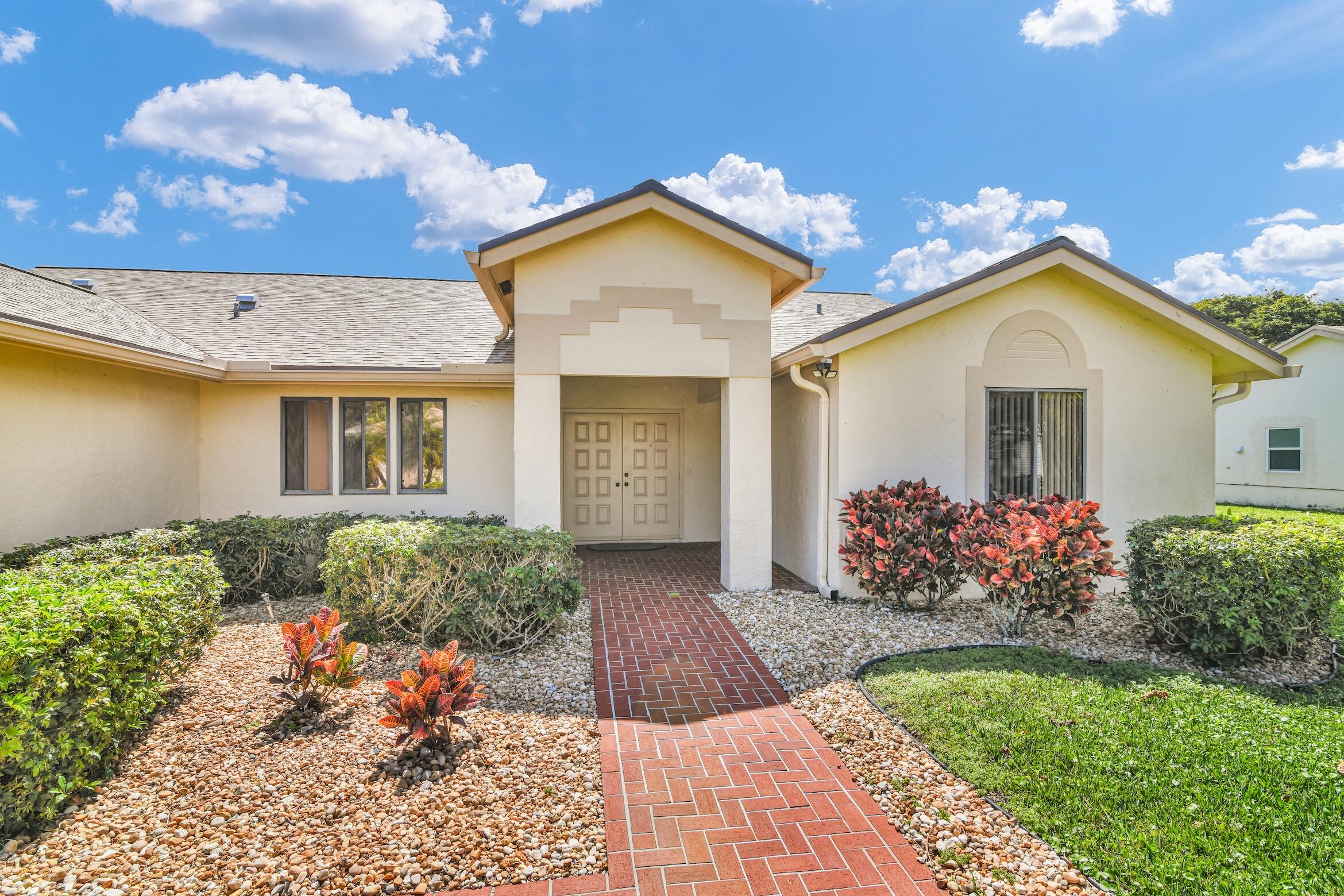 2660 Riviera Drive Delray Beach, FL 33445 - Photo 2 of 40 front view of a house with a yard