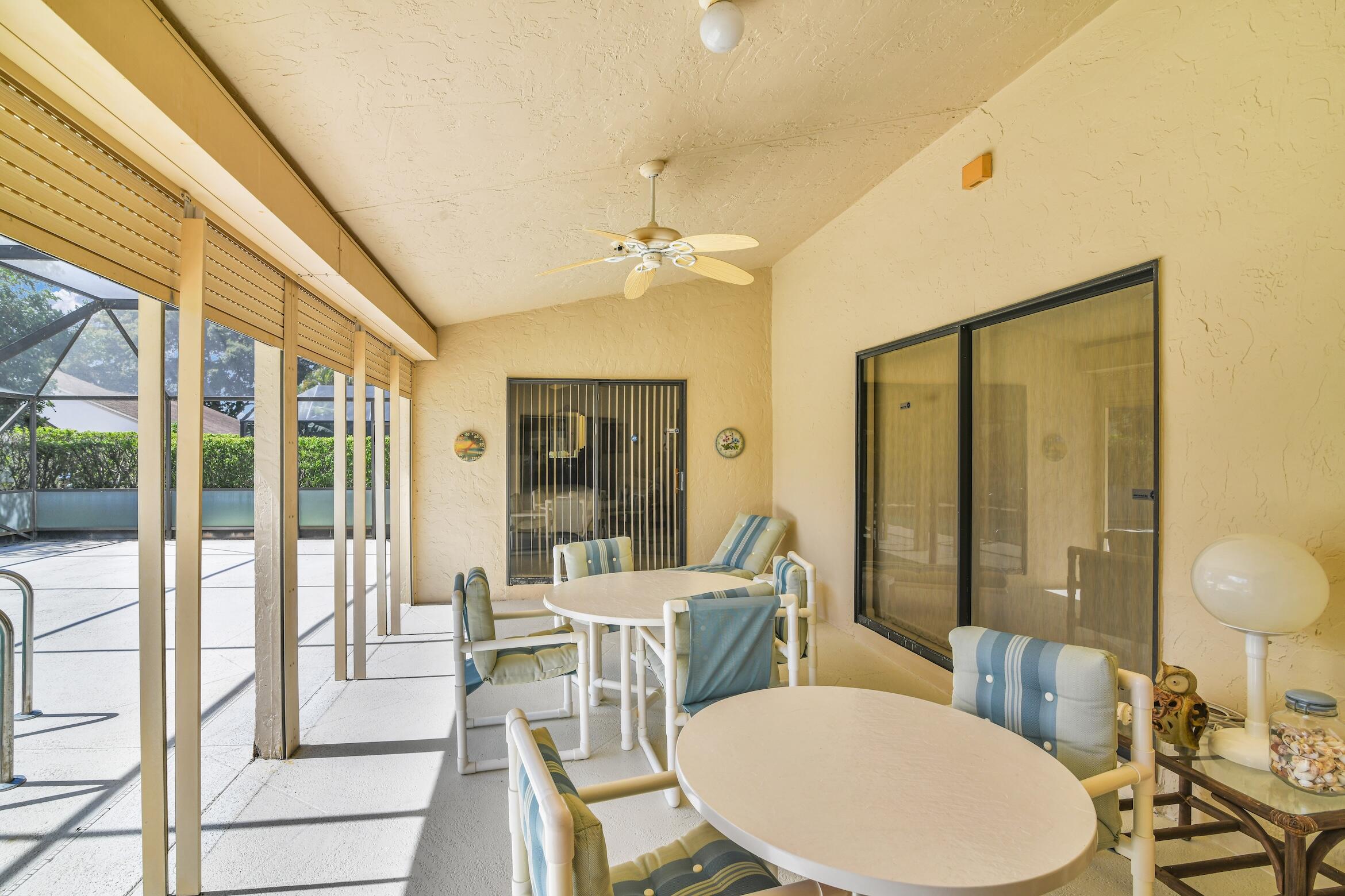 2660 Riviera Drive Delray Beach, FL 33445 - Photo 26 of 40 a view of a dining room with furniture a chandelier and wooden floor