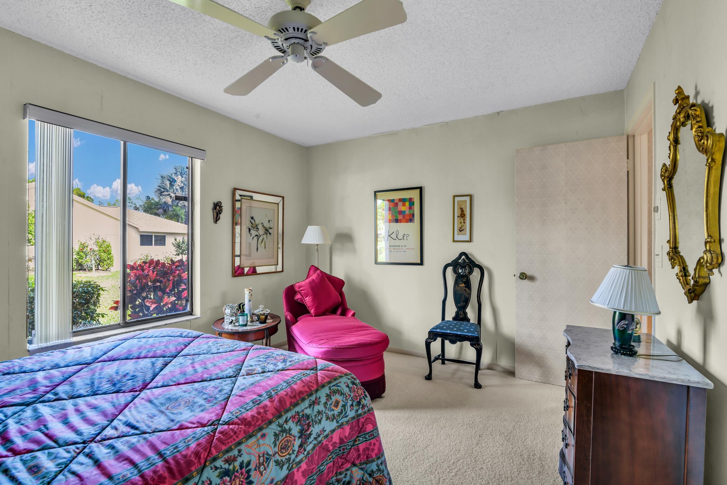2660 Riviera Drive Delray Beach, FL 33445 - Photo 31 of 40 a bedroom with a bed and a chandelier
