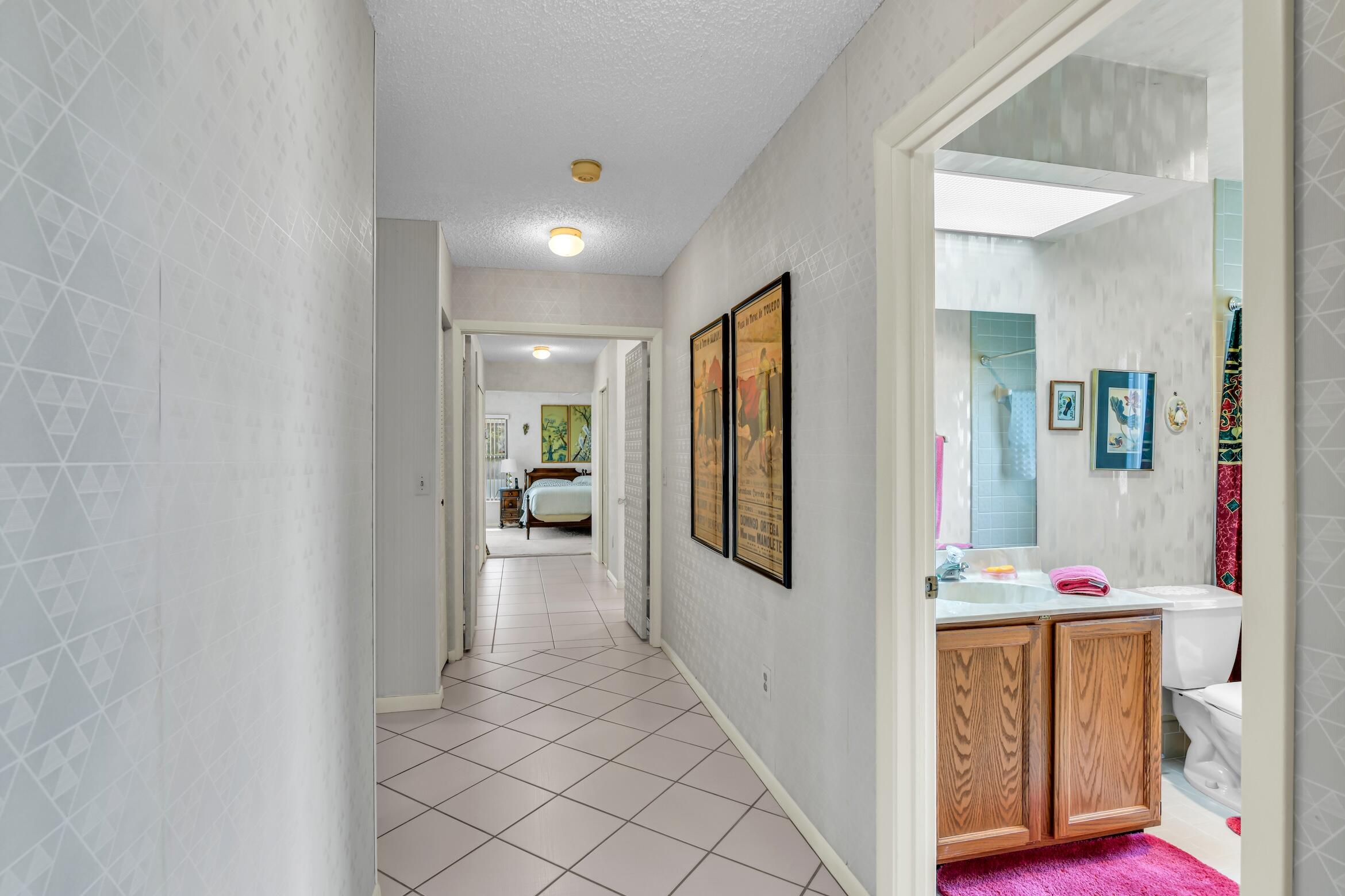 2660 Riviera Drive Delray Beach, FL 33445 - Photo 33 of 40 a view of hallway with walk in closet and wooden floor