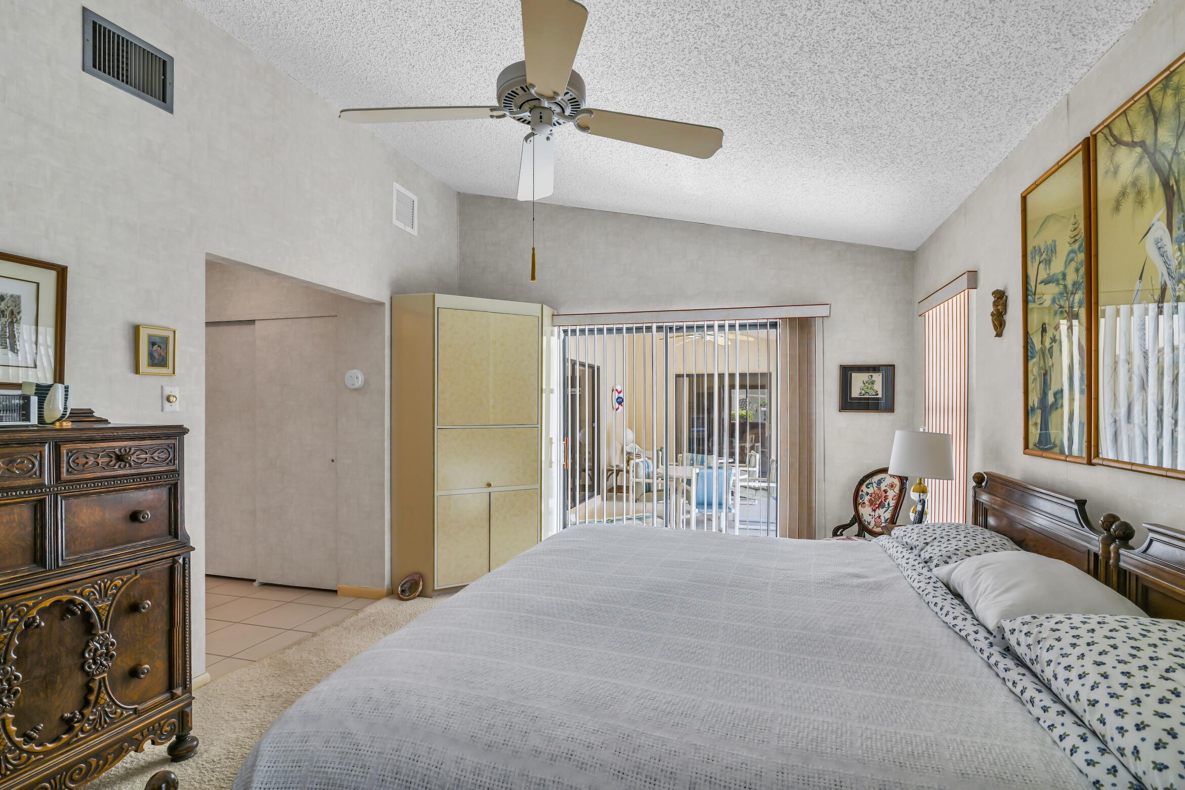 2660 Riviera Drive Delray Beach, FL 33445 - Photo 39 of 40 a bed room with a bed and a chair