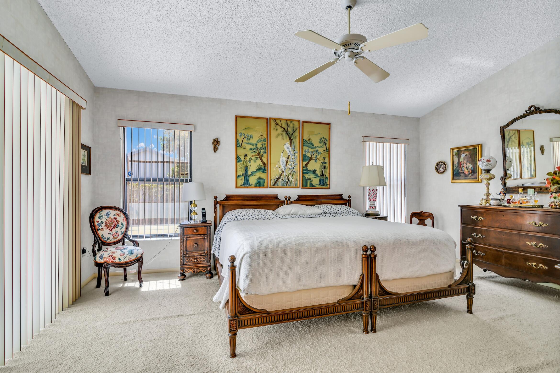 2660 Riviera Drive Delray Beach, FL 33445 - Photo 40 of 40 a bedroom with a bed and a chandelier