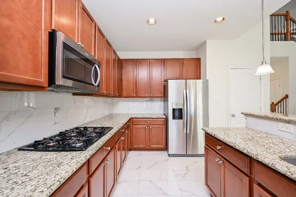 a bathroom with a granite countertop sink a mirror and shower