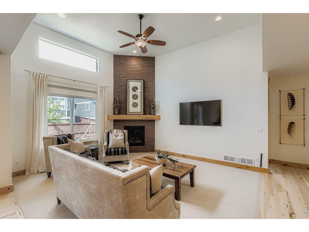 2012 Day Spring Drive Windsor, CO 80550 - Photo 6 of 32 Floor to ceiling brick fireplace anchors this bright living space.