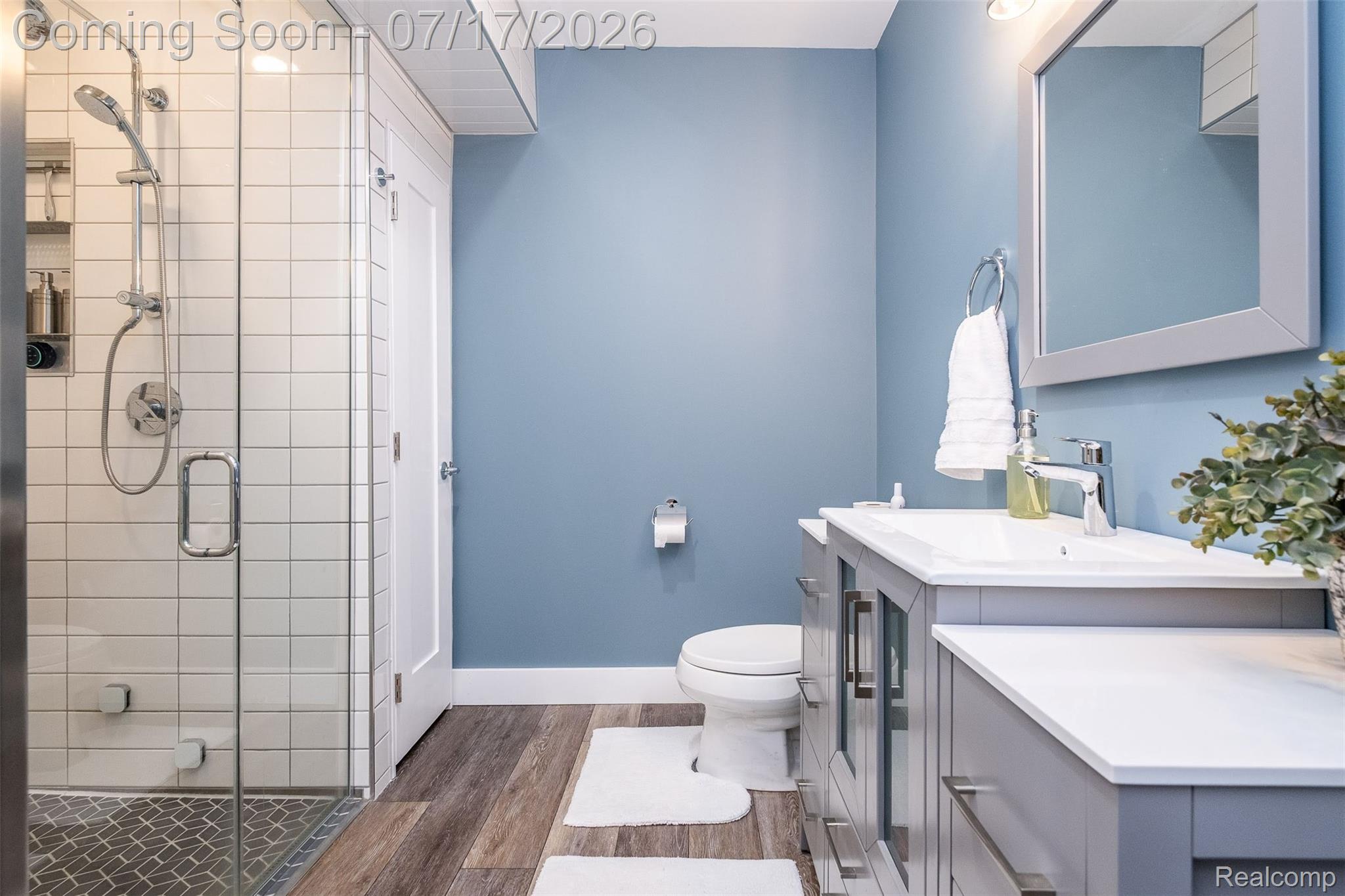 12349 Sugar Maple Drive Fenton, MI 48430 - Photo 45 of 67 Modern bathroom featuring a glass-enclosed shower with subway tile surround and pebble tile flooring