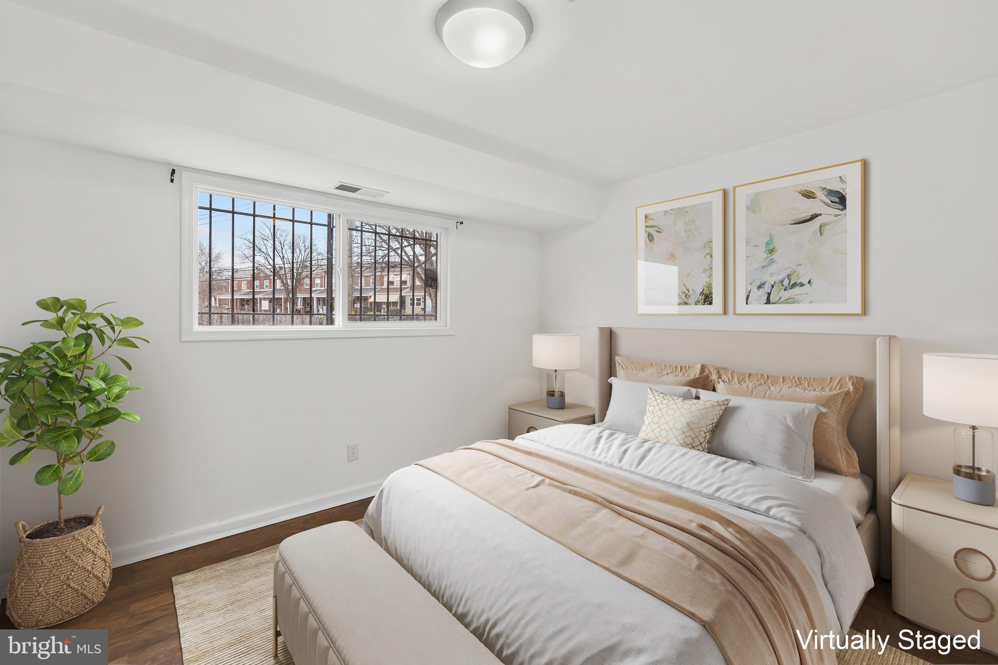 1386 Bryant Street Northeast, Unit 103 Washington, DC 20018 - Photo 12 of 28 a bedroom with a bed and a potted plant