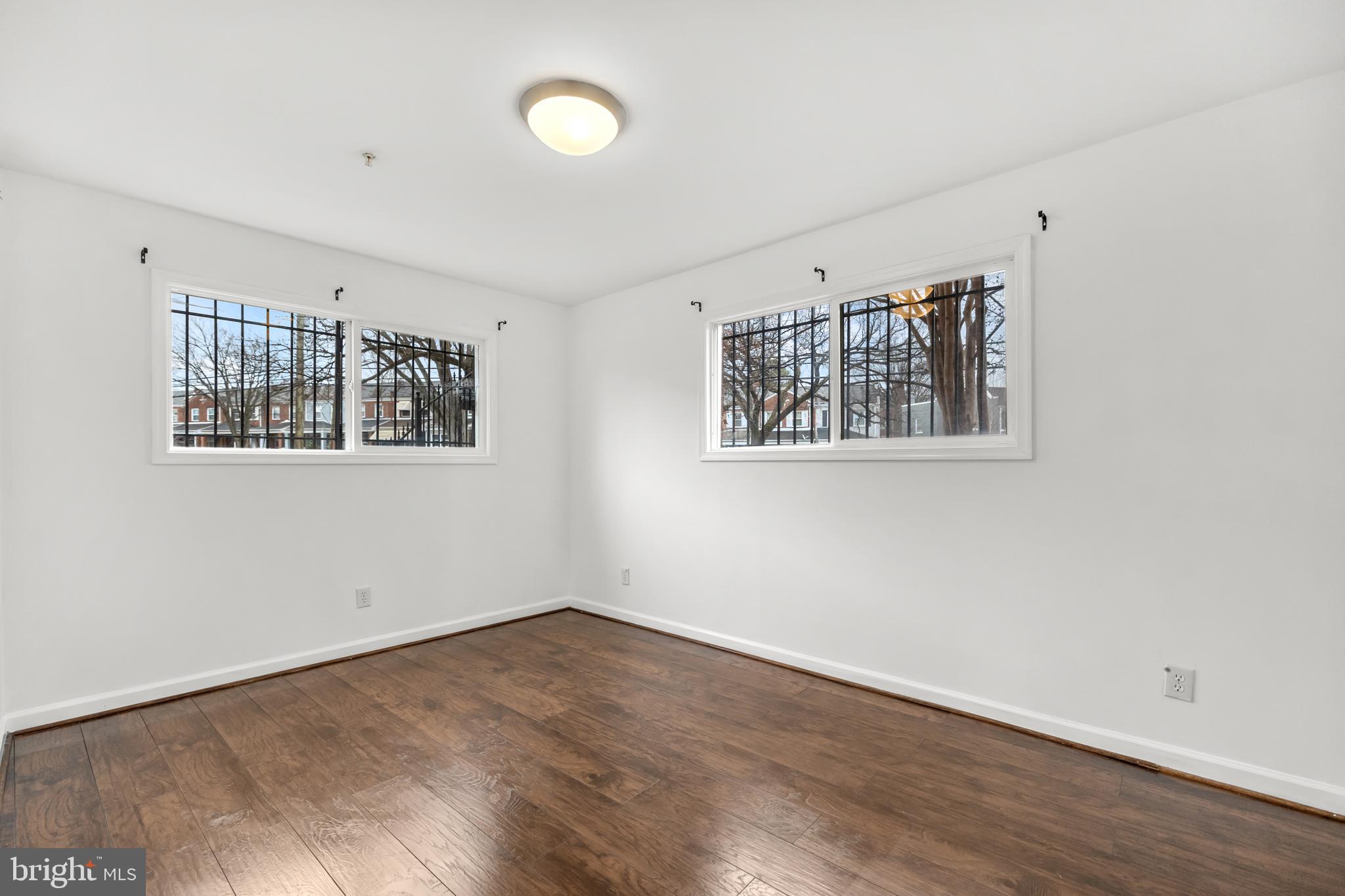 1386 Bryant Street Northeast, Unit 103 Washington, DC 20018 - Photo 13 of 28 a view of a room with wooden floor and window