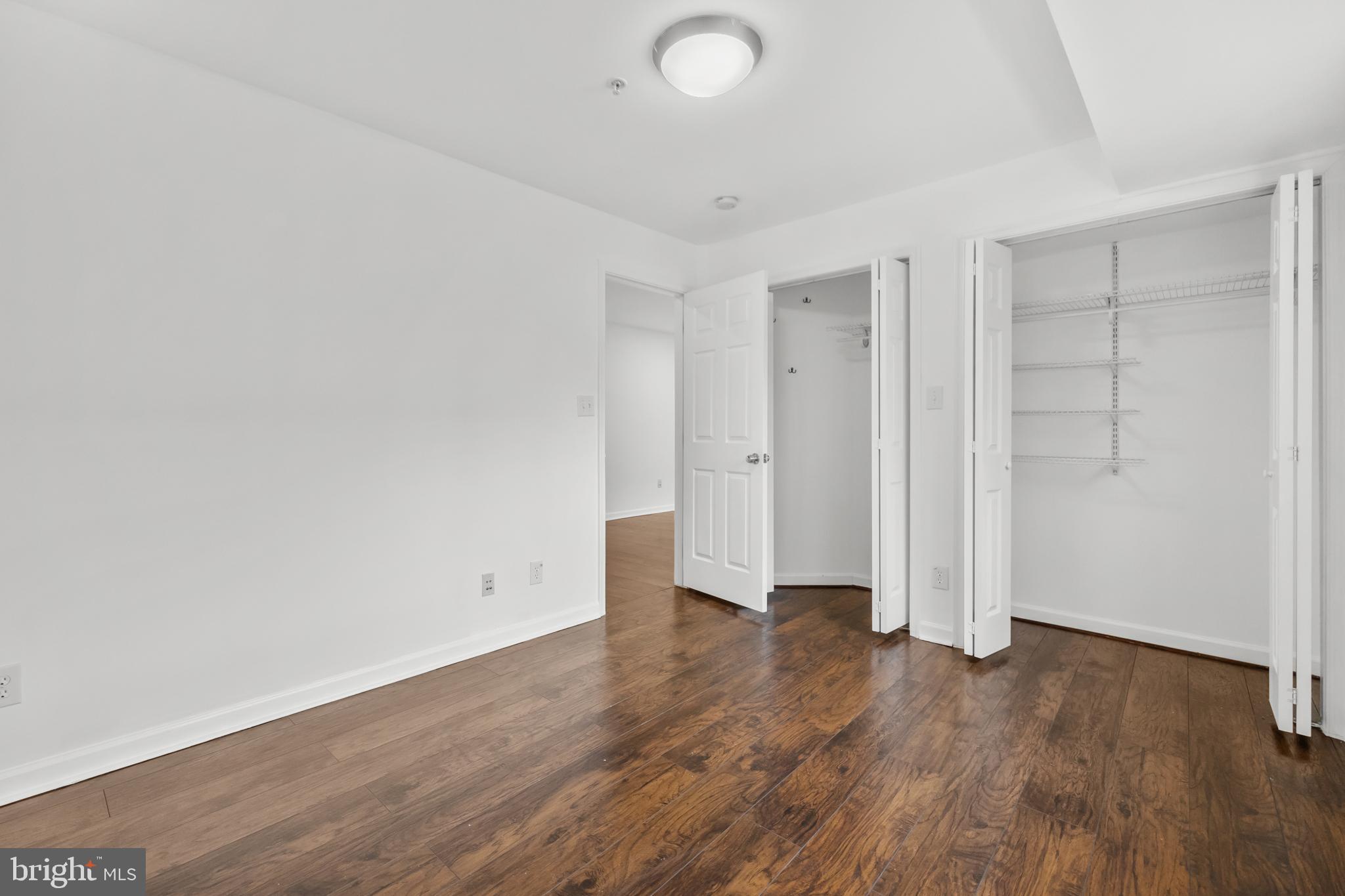 1386 Bryant Street Northeast, Unit 103 Washington, DC 20018 - Photo 14 of 28 an empty room with wooden floor