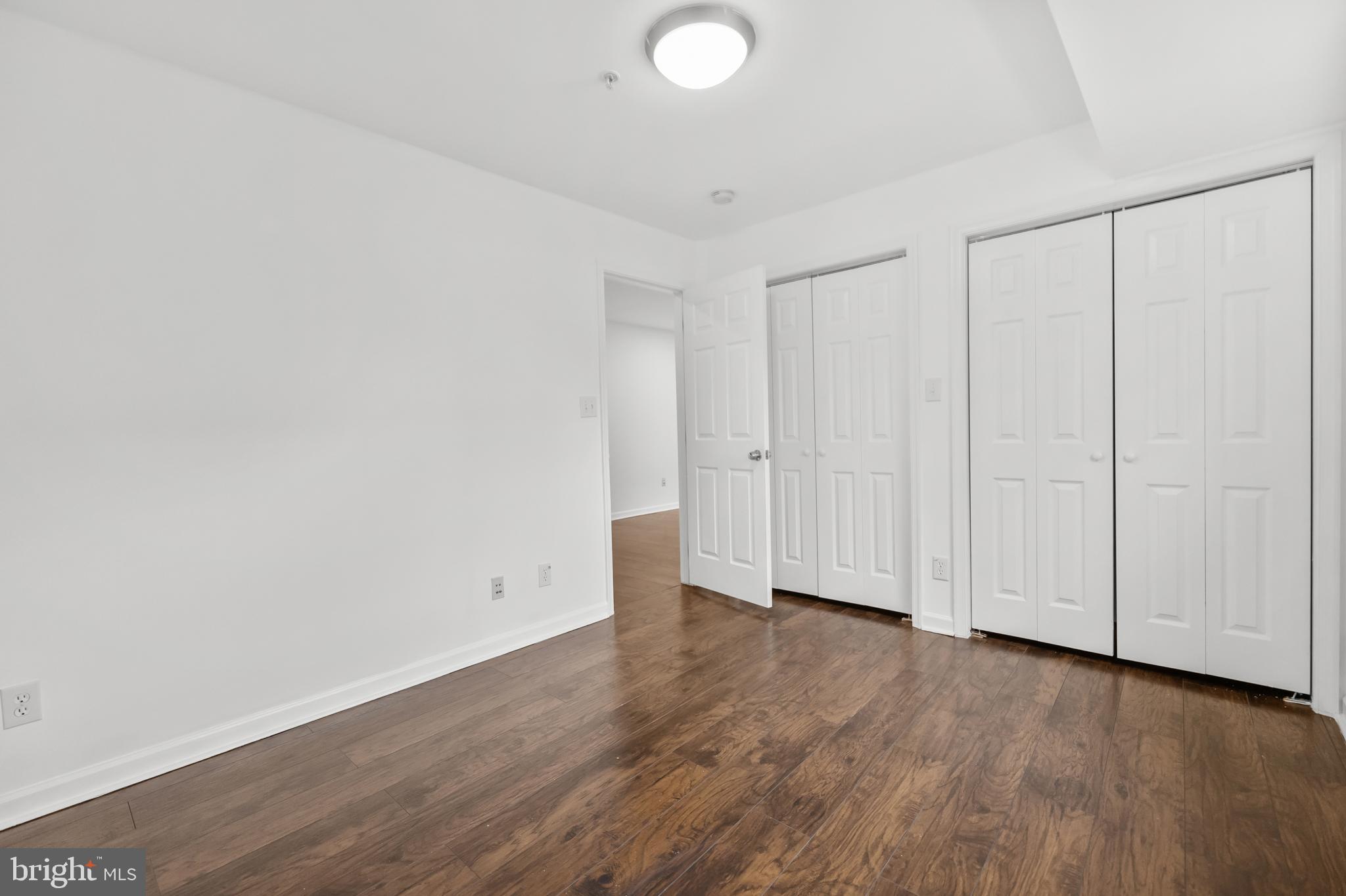1386 Bryant Street Northeast, Unit 103 Washington, DC 20018 - Photo 15 of 28 a view of an empty room with wooden floor