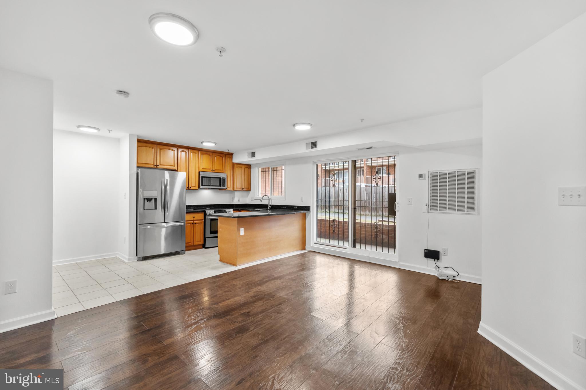 1386 Bryant Street Northeast, Unit 103 Washington, DC 20018 - Photo 2 of 28 a view of kitchen with wooden floor