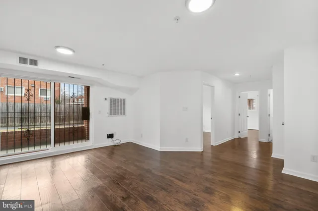 a view of wooden floor and windows in an empty room