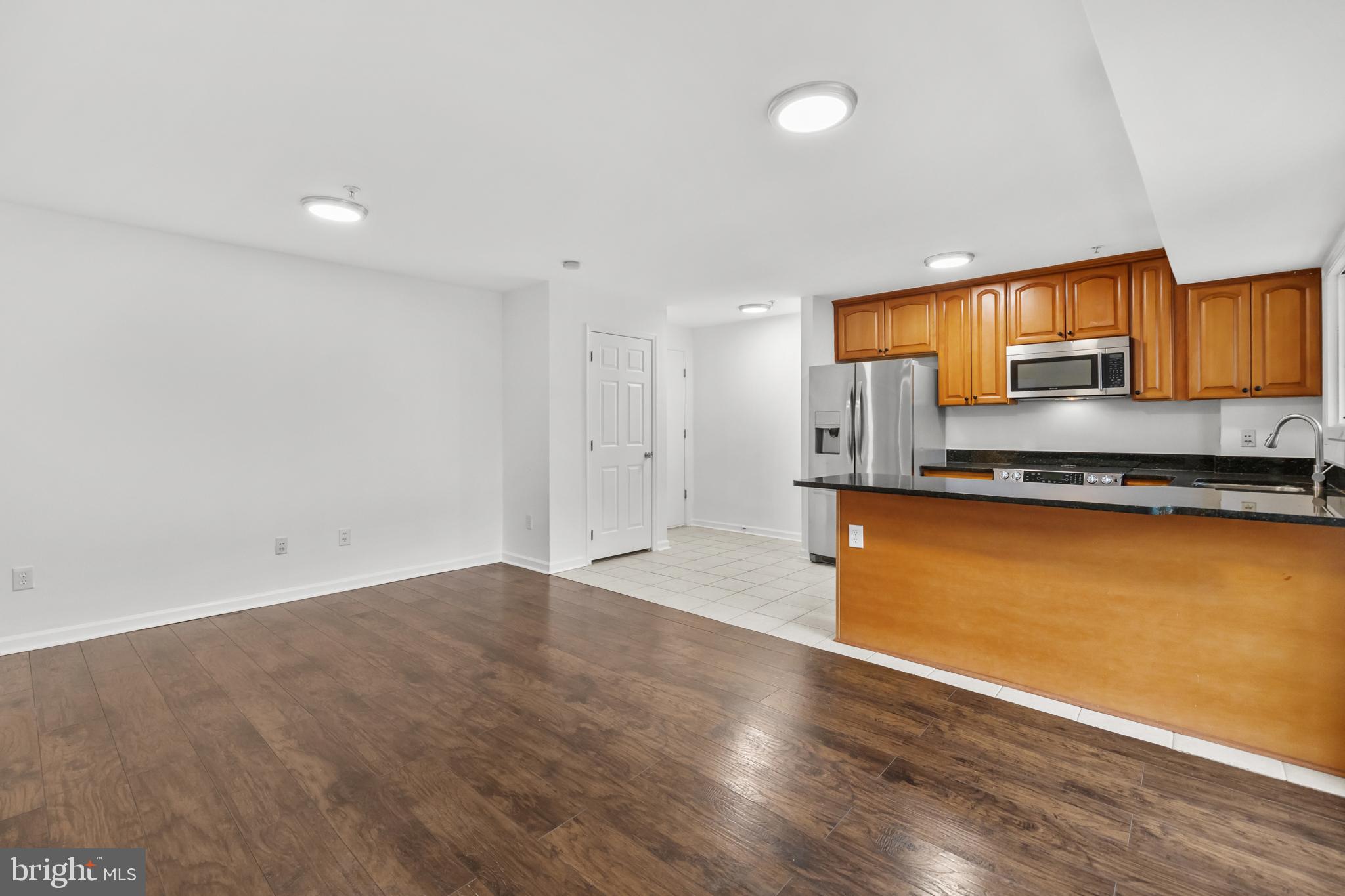 1386 Bryant Street Northeast, Unit 103 Washington, DC 20018 - Photo 5 of 28 a view of kitchen with wooden floor