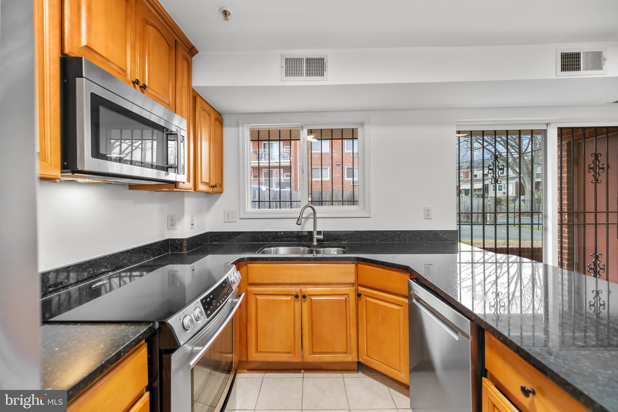 1386 Bryant Street Northeast, Unit 103 Washington, DC 20018 - Photo 7 of 28 a view of a kitchen with a sink and furniture