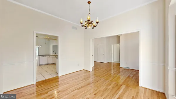 wooden floor in an empty room with a ceiling fan