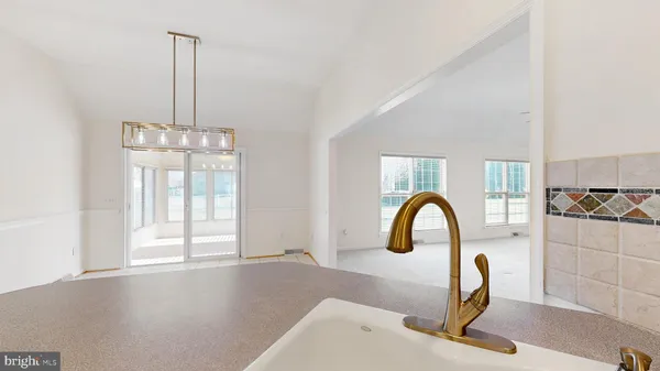 a kitchen with white cabinets and appliances