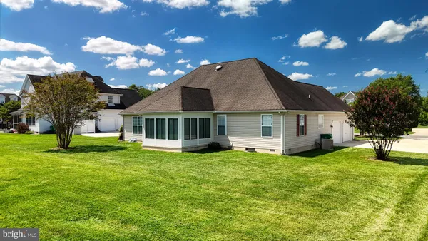 an aerial view of a house with a yard basket ball court and outdoor seating