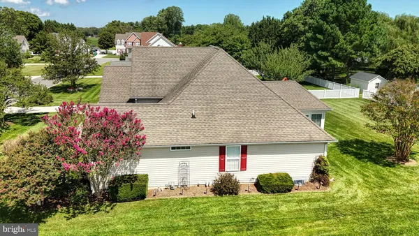 an aerial view of residential houses with outdoor space and trees