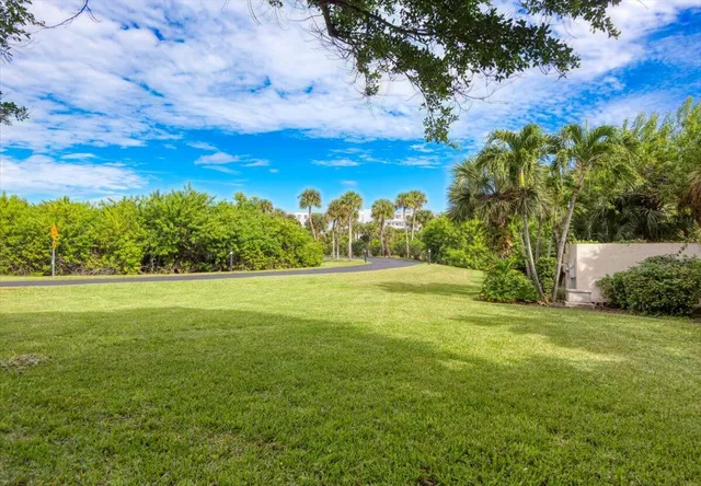 an aerial view of a house with a yard and lake view