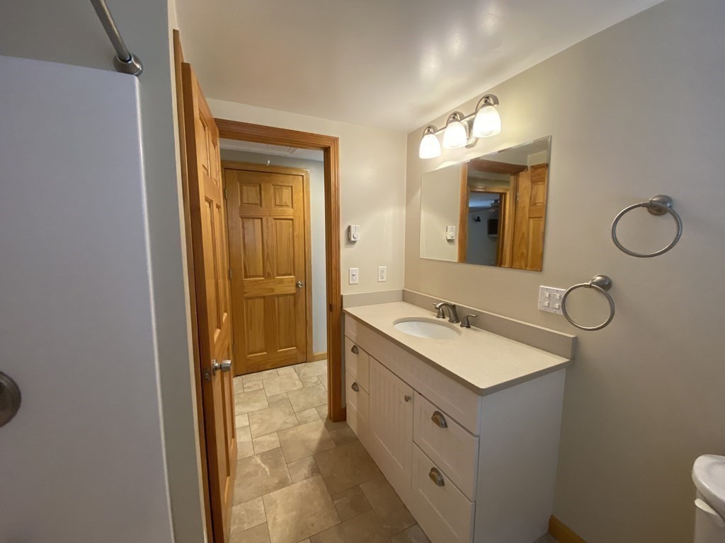 66 Scituate Road Mashpee, MA 02649 - Photo 15 of 33 a bathroom with a sink vanity granite tub and a mirror