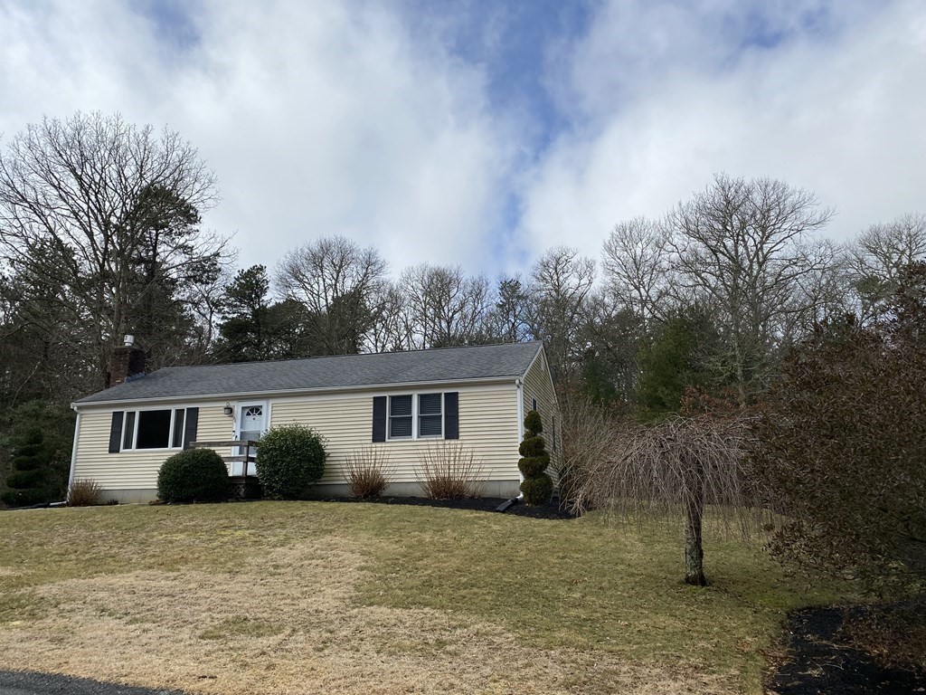 66 Scituate Road Mashpee, MA 02649 - Photo 26 of 33 a front view of house with yard and trees around