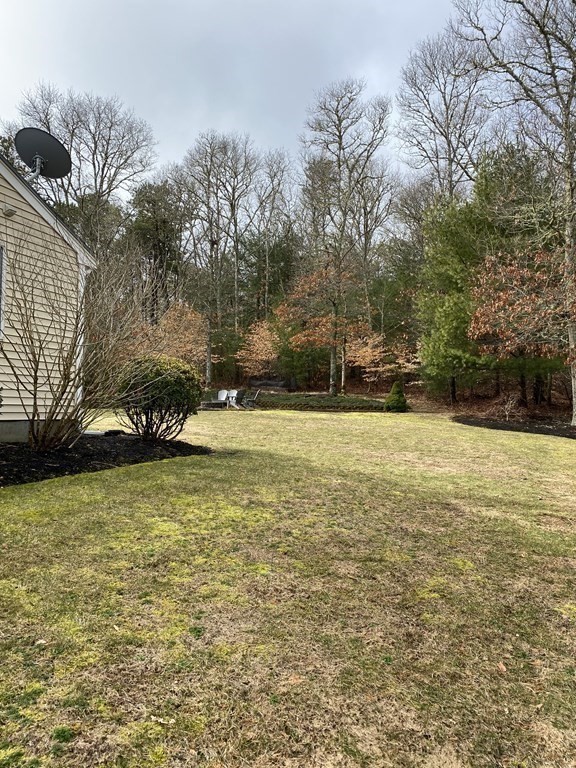 66 Scituate Road Mashpee, MA 02649 - Photo 30 of 33 a view of a yard with a house