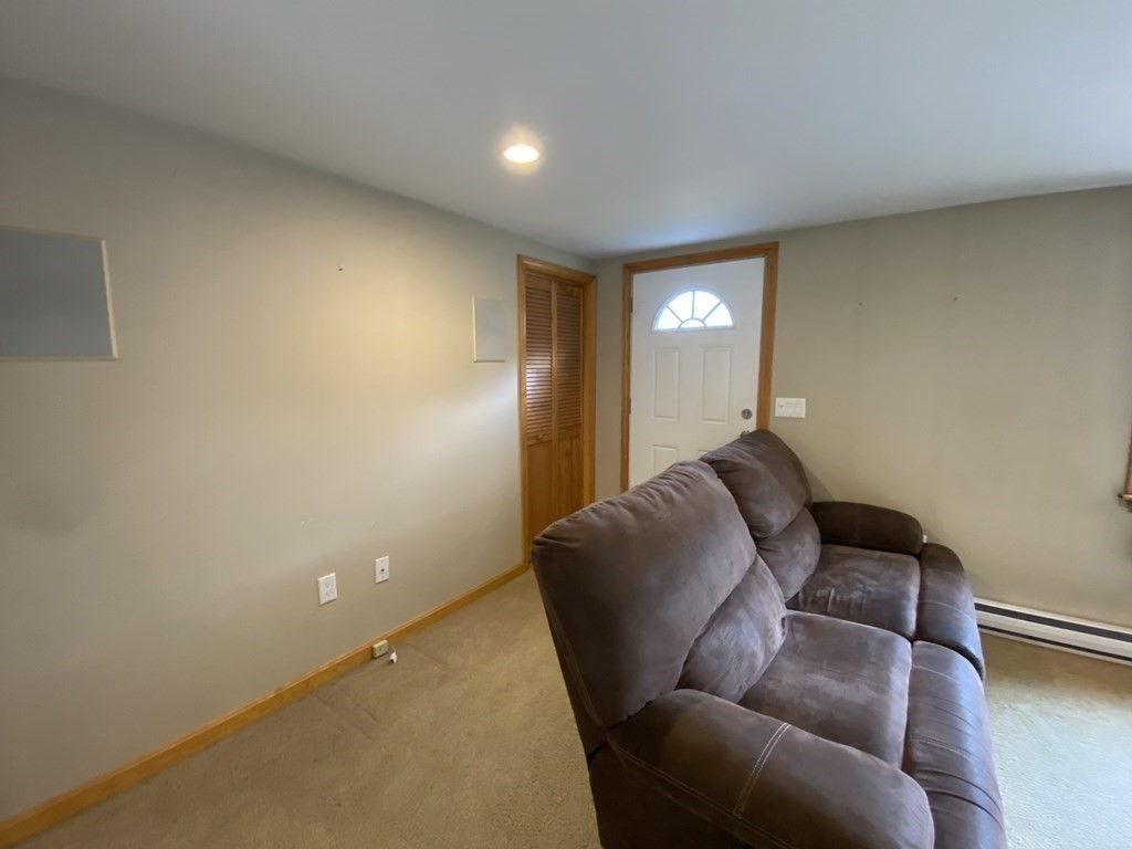 66 Scituate Road Mashpee, MA 02649 - Photo 4 of 33 a living room with furniture and a potted plant