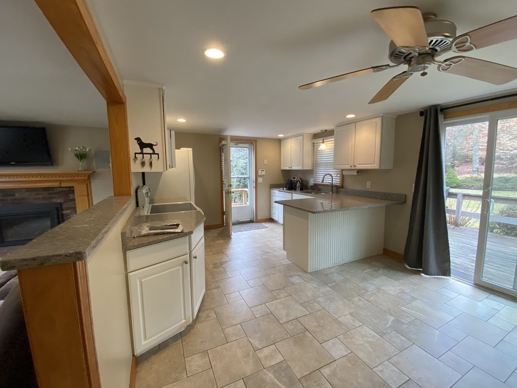 66 Scituate Road Mashpee, MA 02649 - Photo 6 of 33 a kitchen with a sink appliances and cabinets