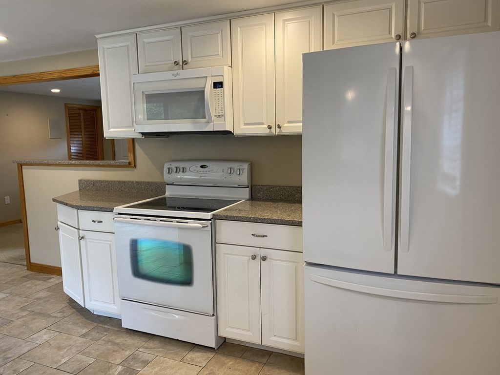 66 Scituate Road Mashpee, MA 02649 - Photo 8 of 33 a kitchen with stainless steel appliances white cabinets and white appliances