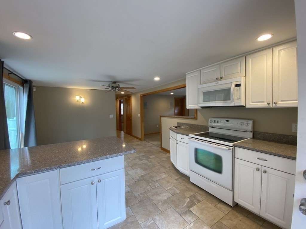 66 Scituate Road Mashpee, MA 02649 - Photo 9 of 33 a kitchen with stainless steel appliances white cabinets and sink