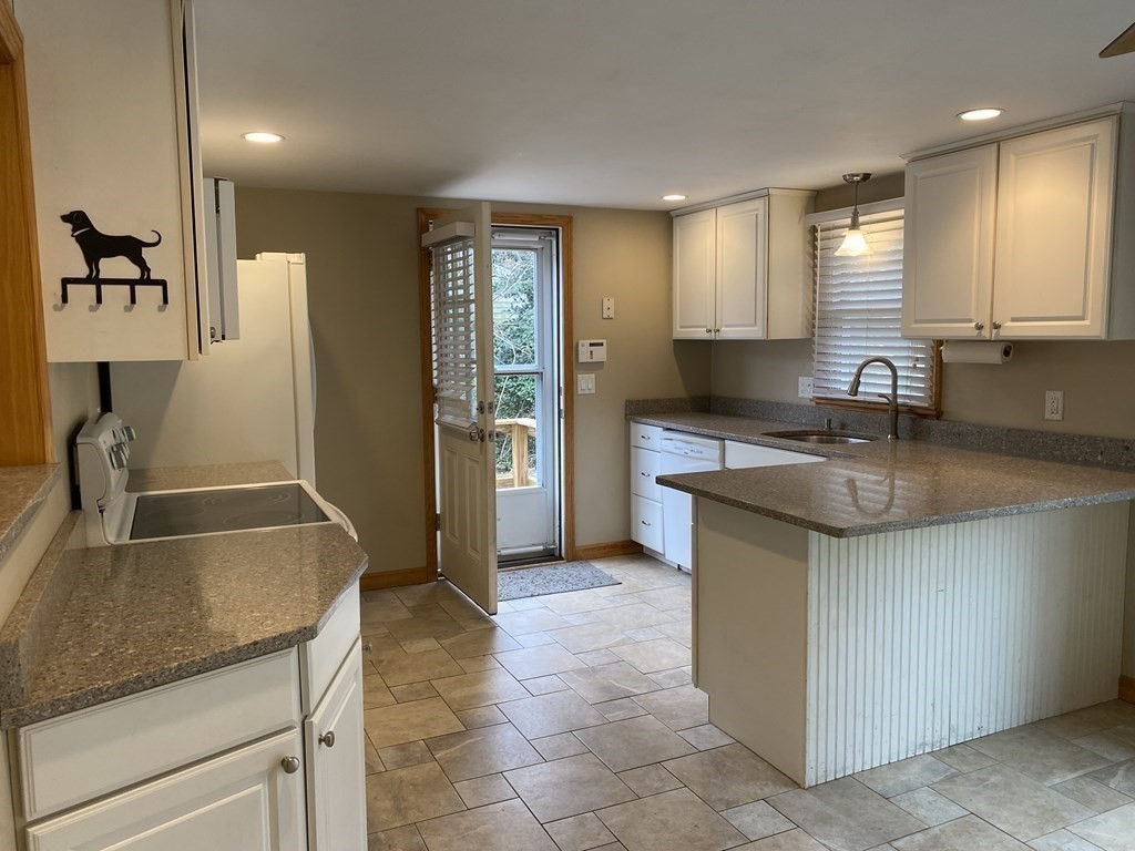 66 Scituate Road Mashpee, MA 02649 - Photo 10 of 33 a kitchen with stainless steel appliances granite countertop a sink stove and refrigerator