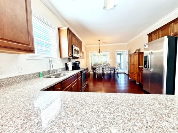 a view of a living room and kitchen with a sink