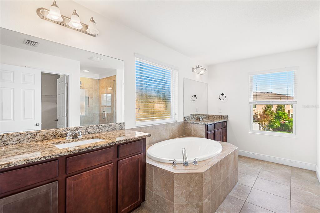 1848 Oak Hammock Court Lutz, FL 33558 - Photo 14 of 25 a bathroom with a granite countertop sink and a mirror