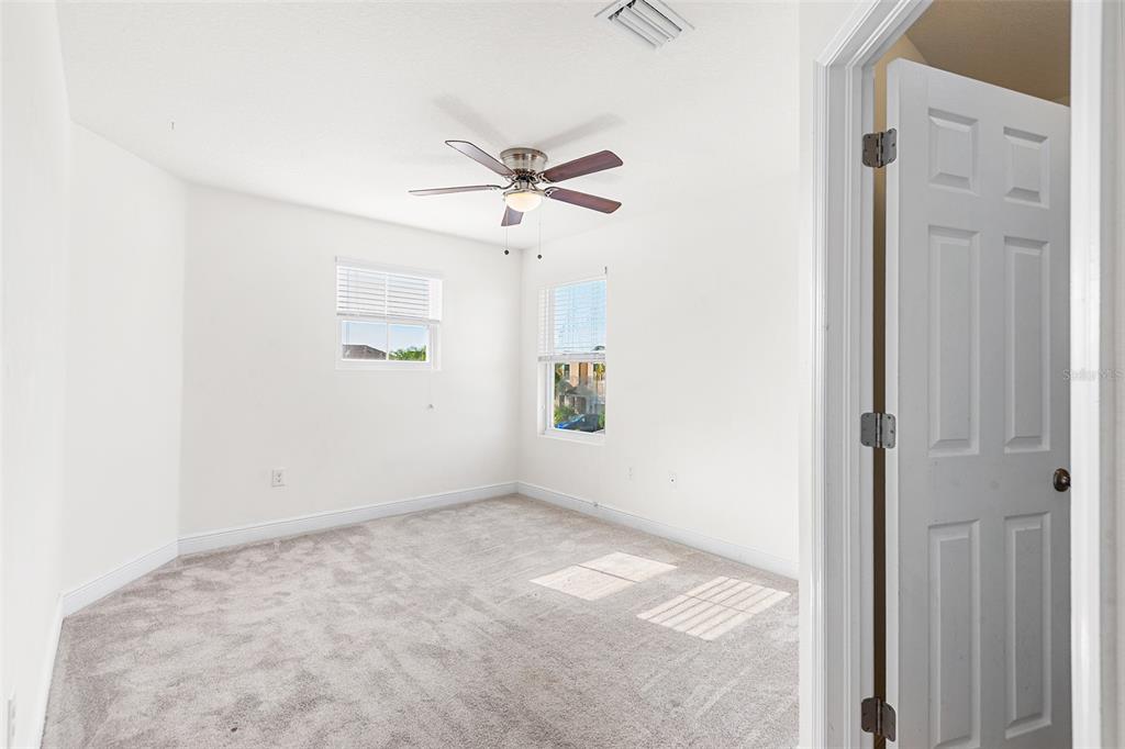 1848 Oak Hammock Court Lutz, FL 33558 - Photo 19 of 25 a view of room with a ceiling fan and window