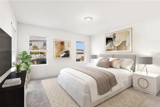 a bedroom with a large bed and a couch