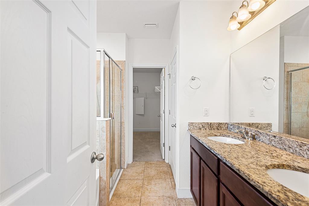 1848 Oak Hammock Court Lutz, FL 33558 - Photo 7 of 25 a bathroom with a granite countertop sink and a mirror