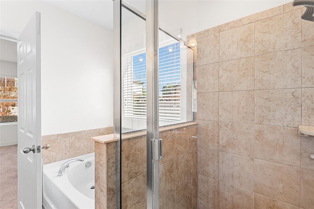 1848 Oak Hammock Court Lutz, FL 33558 - Photo 9 of 25 a bathroom with a bathtub and shower