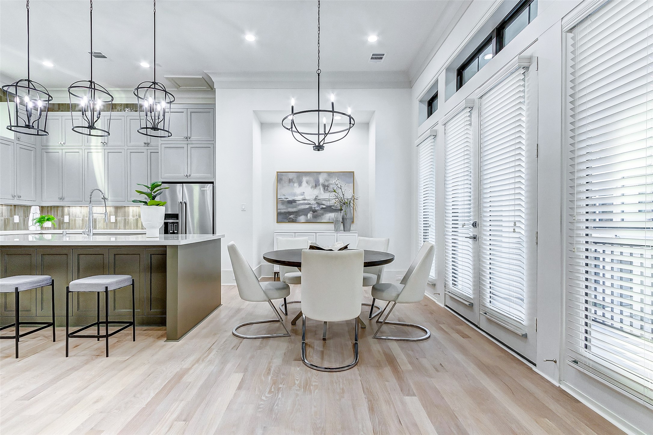 2122 Blalock Road, Unit B Houston, TX 77080 - Photo 18 of 48 a dining room with wooden floor a chandelier a glass table and chairs