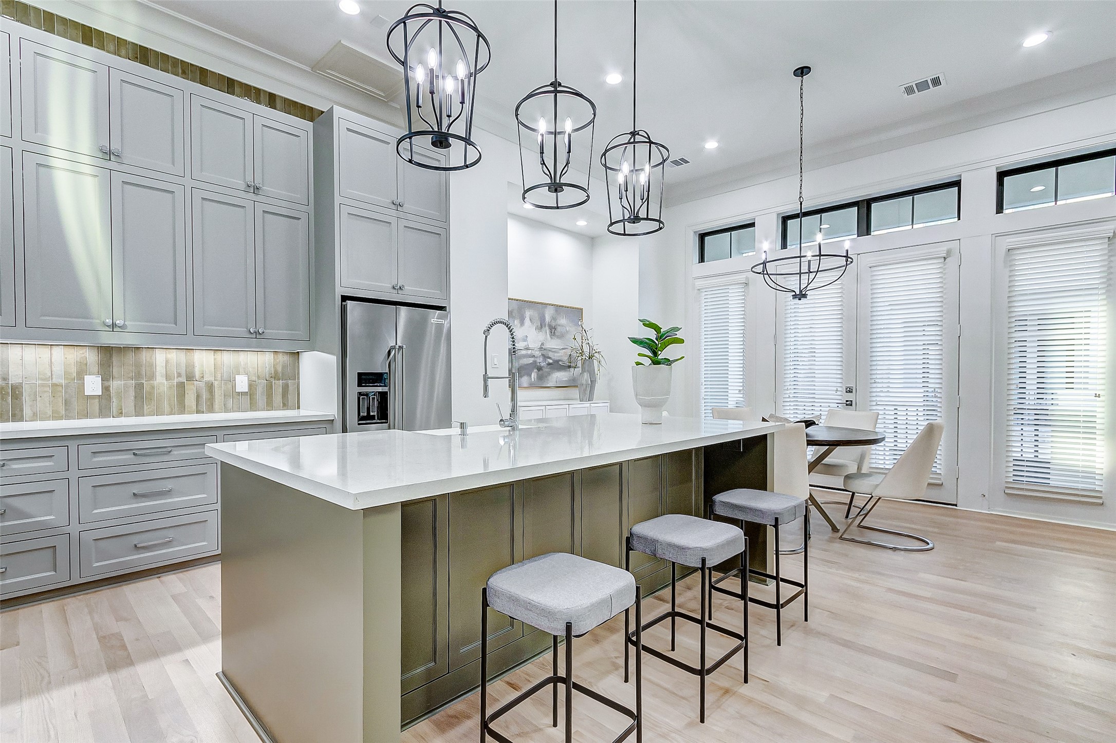 2122 Blalock Road, Unit B Houston, TX 77080 - Photo 25 of 48 a kitchen with stainless steel appliances a table chairs and wooden floor