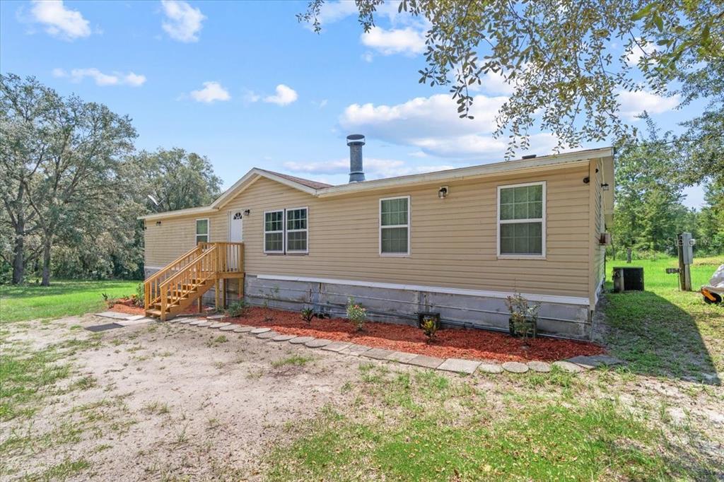 13120 Southwest 90th Street Dunnellon, FL 34432 - Photo 1 of 24 a view of a house with backyard and trees