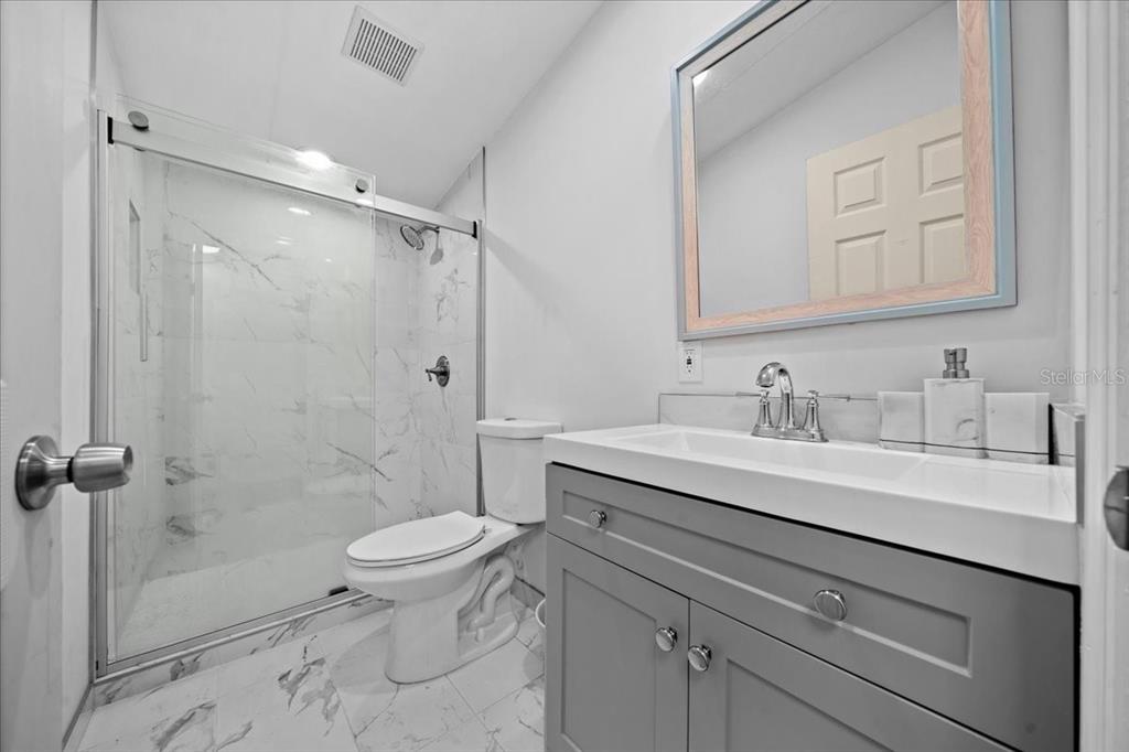 13120 Southwest 90th Street Dunnellon, FL 34432 - Photo 11 of 24 a bathroom with a sink toilet double vanity and shower