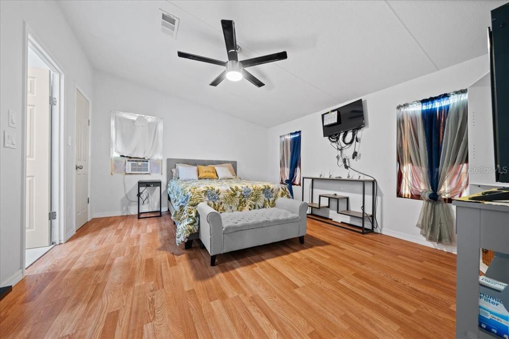 13120 Southwest 90th Street Dunnellon, FL 34432 - Photo 15 of 24 a bedroom with a bed and a flat screen tv