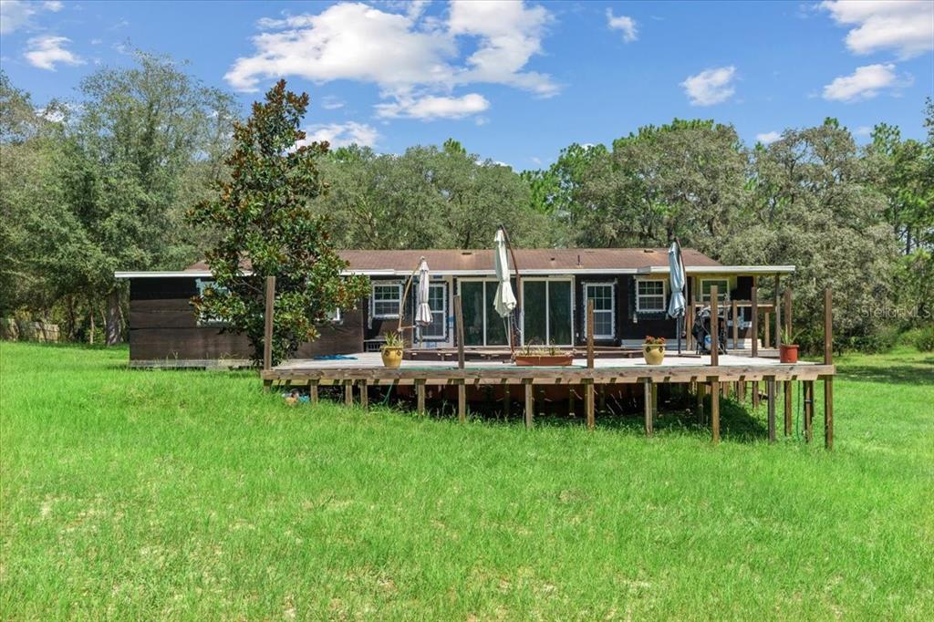 13120 Southwest 90th Street Dunnellon, FL 34432 - Photo 3 of 24 a view of a house with a backyard and sitting area